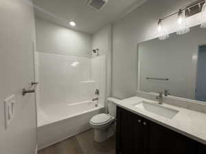 Bathroom with  shower combination, vanity, dark wood-type flooring, and recessed lighting