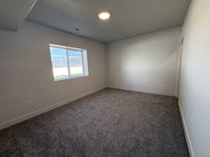 Carpeted empty room with baseboards