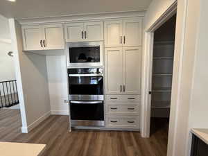 Kitchen with appliances with stainless steel finishes and dark wood-style floors