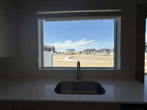 Kitchen featuring a residential view and light stone countertops