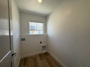 Laundry room with a textured ceiling, light wood-style floors, washer hookup, and electric dryer hookup