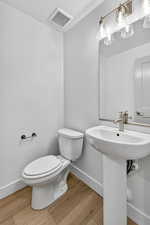 Bathroom with baseboards and light wood-style flooring