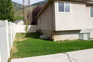View of side of home with a mountain view and stucco siding