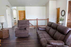 Living area featuring dark wood finished floors and arched walkways