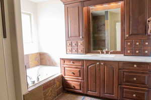 Full bathroom with vanity and a whirlpool tub
