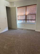 Empty room with dark colored carpet