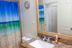 Bathroom featuring vanity, curtained shower, and a water view
