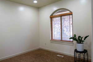 Empty room with carpet and recessed lighting