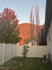 Fenced backyard featuring a mountain view