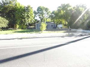 View of front of home featuring view of wooded area
