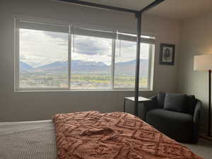 Bedroom featuring a mountain view and carpet