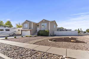 View of front of home with an attached garage and concrete driveway