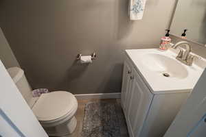 Bathroom with vanity and dark wood-type flooring