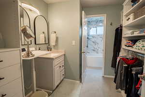 Bathroom featuring vanity and a bath