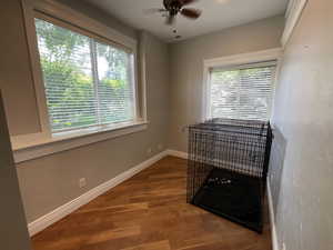 Bedroom featuring dark wood-style floors and ceiling fan