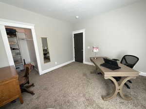 Carpeted office featuring baseboards