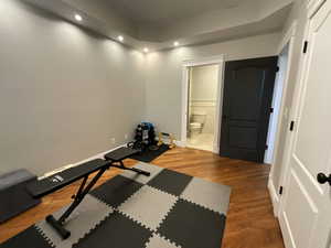Workout room with recessed lighting and light wood-style floors