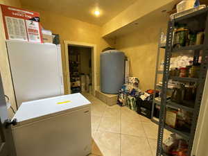 Laundry room with light tile patterned floors