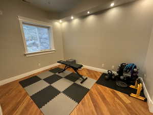 Workout room featuring recessed lighting and wood finished floors