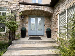 View of exterior entry with stone siding
