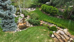 View of green lawn with a garden pond