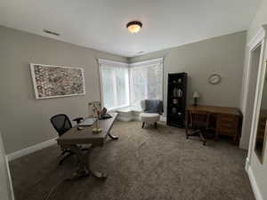 Home office with carpet floors and baseboards
