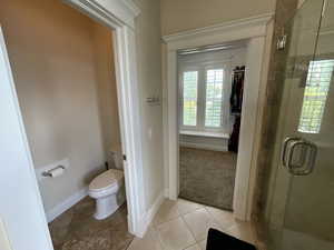 Full bathroom with a shower stall and light tile patterned floors