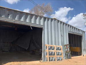 View of outbuilding featuring a garage