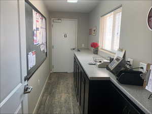 Kitchen featuring dark cabinetry and dark wood finished floors