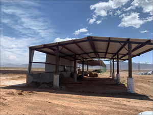 View of vehicle parking with a mountain view and a detached carport