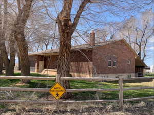 View of side of property with a chimney and brick siding