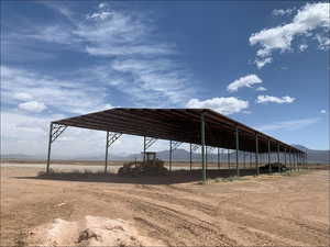 View of parking / parking lot with a rural view and a mountain view