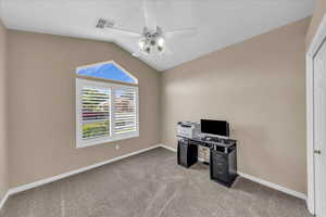 Unfurnished office with lofted ceiling, light carpet, and a ceiling fan