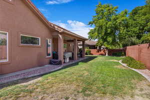 Fenced backyard with a patio