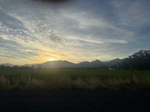 View of mountain background featuring rural landscape