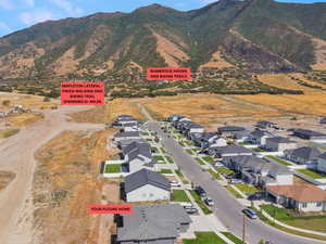 Aerial view of residential area featuring a mountainous background