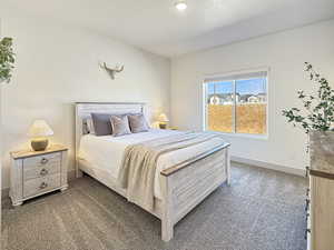 Bedroom with carpet flooring and a textured ceiling