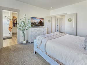 Bedroom featuring carpet flooring and a spacious closet
