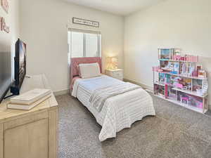 Bedroom featuring carpet floors and baseboards