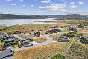 Aerial perspective of suburban area featuring a water and mountain view