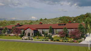 View of front of home featuring a chimney, stone siding, and a front yard
