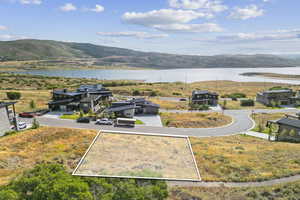 Aerial view of property and surrounding area with property boundaries highlighted and a water and mountain view