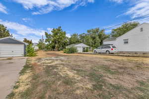 View of yard featuring an outdoor structure and a detached garage