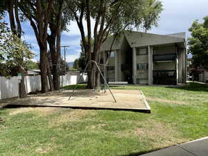 Community play area featuring a yard and a patio