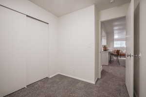 Unfurnished bedroom featuring carpet flooring and a closet