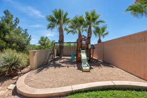 View of play area with a fenced backyard