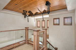 Stairway with wooden ceiling and a raised ceiling