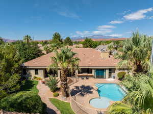 View of swimming pool with a patio area, a residential view, and a mountain view