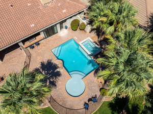 Aerial view of property and surrounding area featuring a pool area