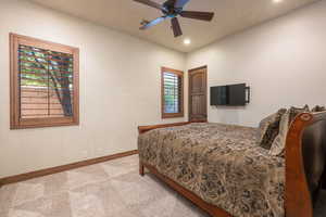 Carpeted bedroom with recessed lighting and ceiling fan